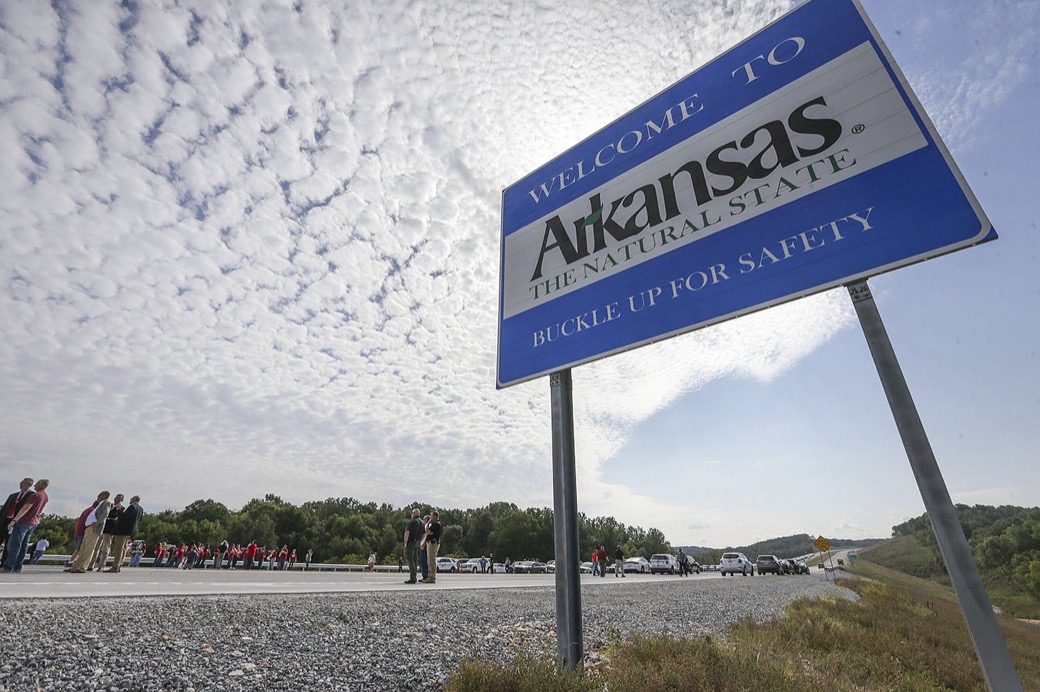 A “Welcome to Arkansas” sign beside a newly opened stretch of highway