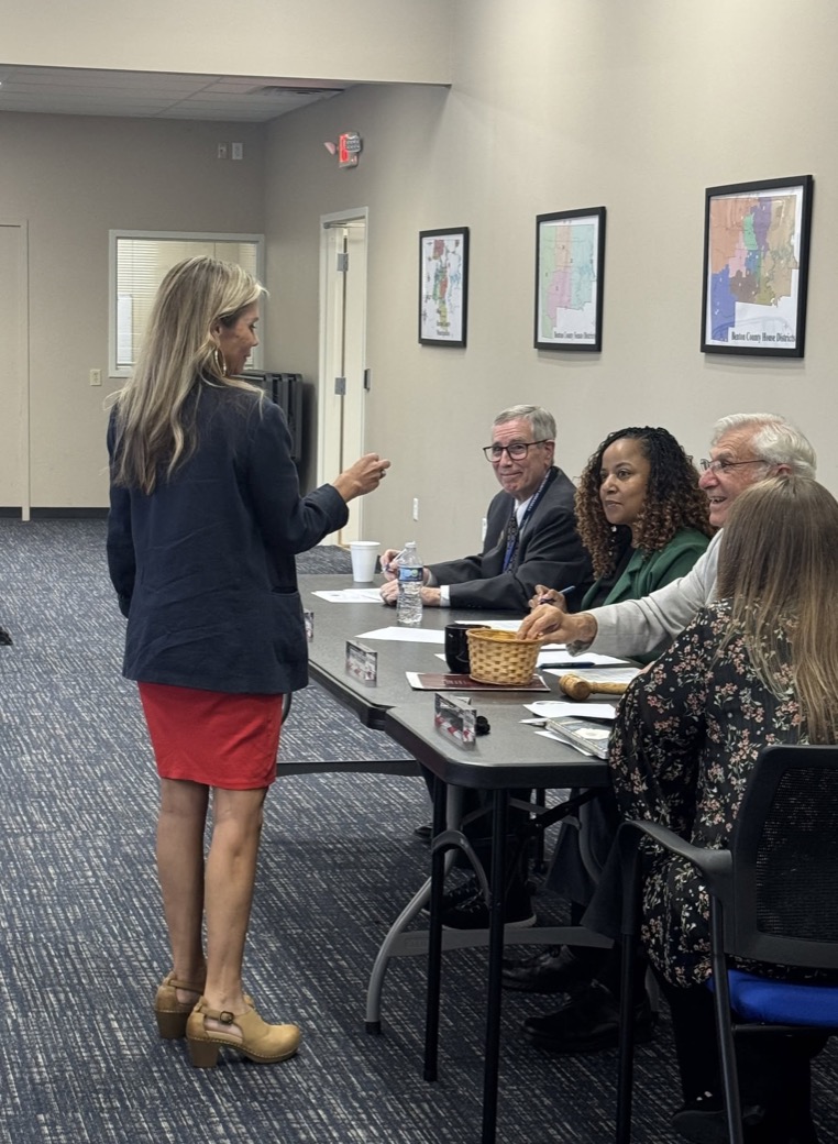Residents and officials talking around a table at a public meeting